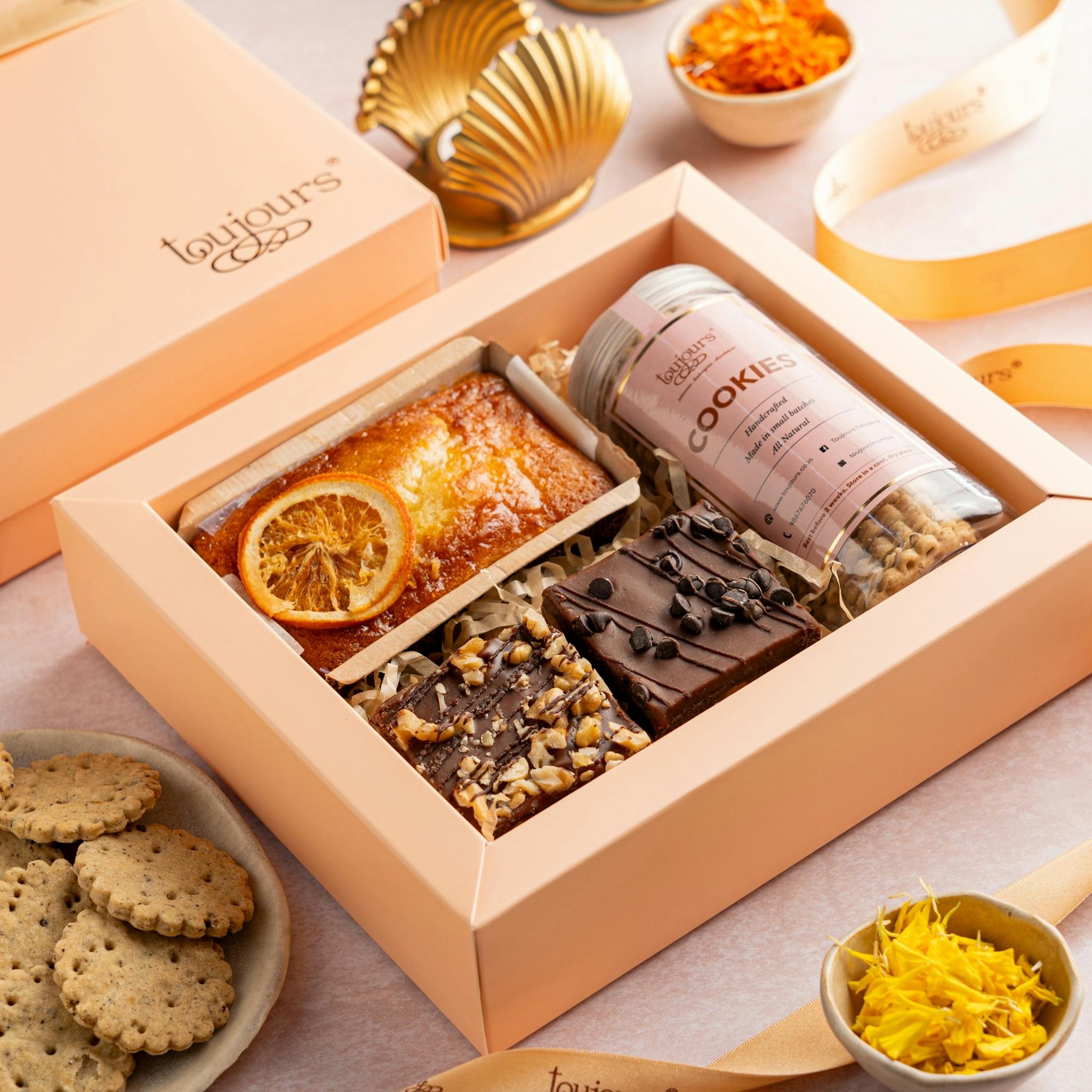 Elegant gift box with baked goods and sweets, perfect for celebrations and gifting.