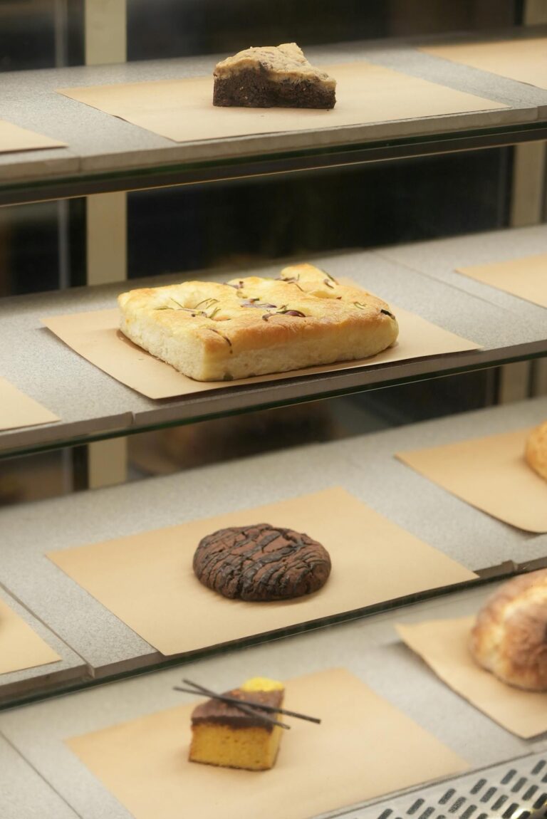 Freshly baked goods neatly arranged in a bakery display case showcasing variety.