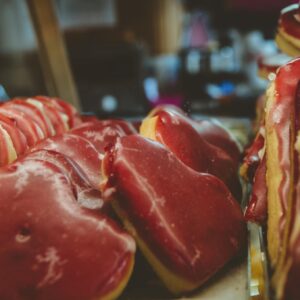 Heart-shaped red cookies on display in a market, showcasing a delicious treat
