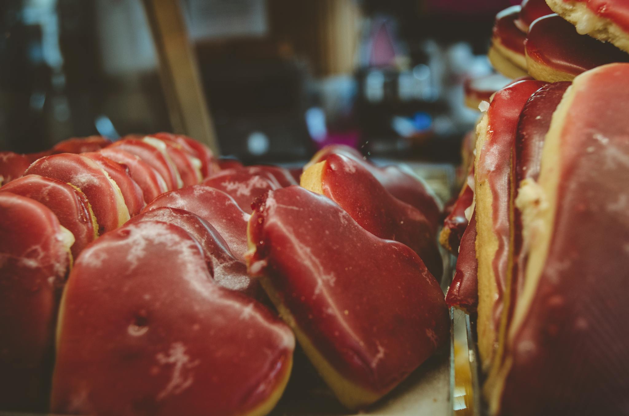 Heart-shaped red cookies on display in a market, showcasing a delicious treat